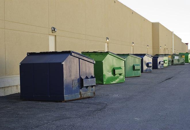 construction workers disposing of debris in large dumpsters in Adamstown, PA